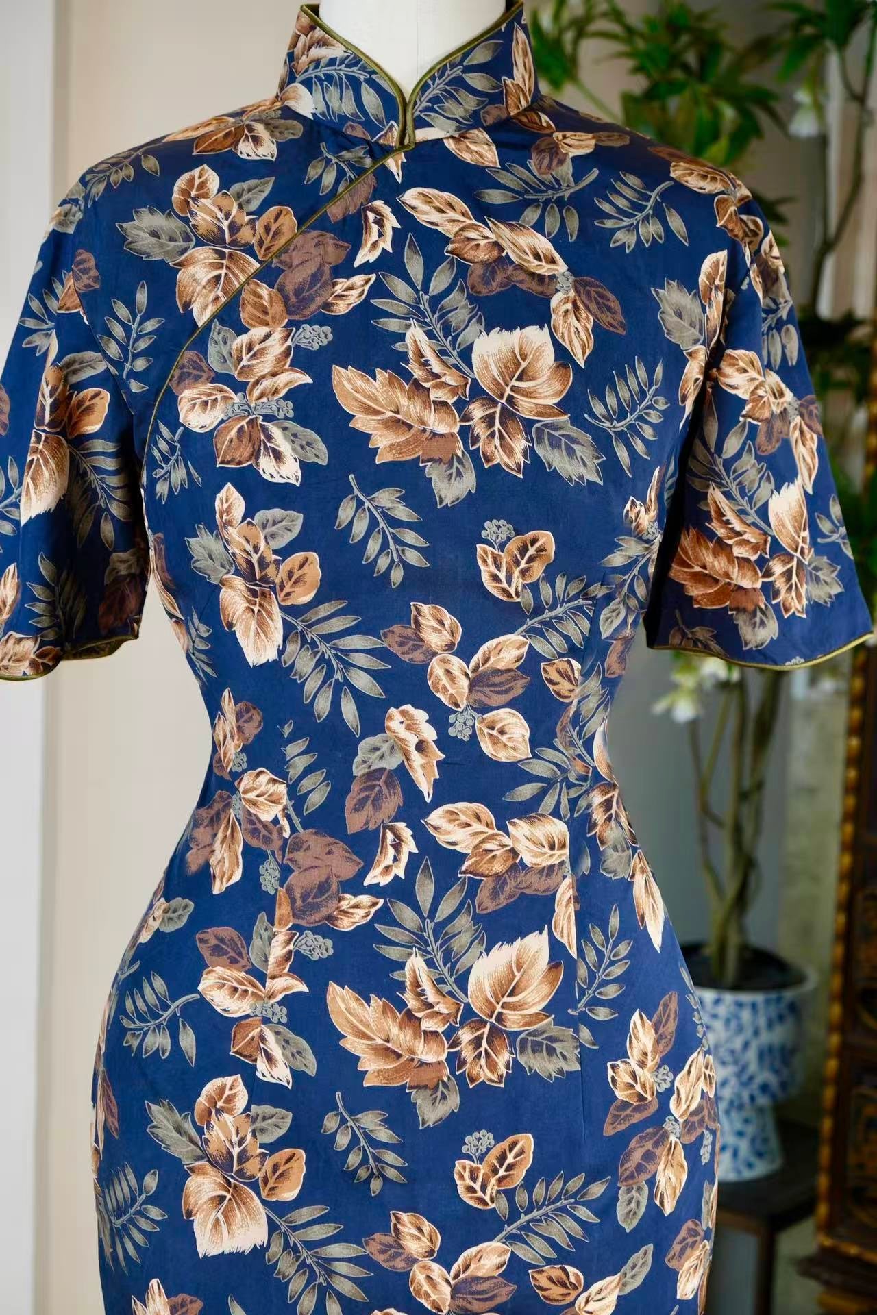 50年代 - 五十年代台湾风华：蓝地棕叶“百草比德”印花古董旗袍 — 迁徙年代的植物图腾与行走的乡愁 | 1950s - 1950s Taiwan Elegance: A Vintage Indigo Cheongsam with "Virtuous Botanical" Brown Leaf Print — A Narrative of Migratory Plant Totems and Walking Nostalgia